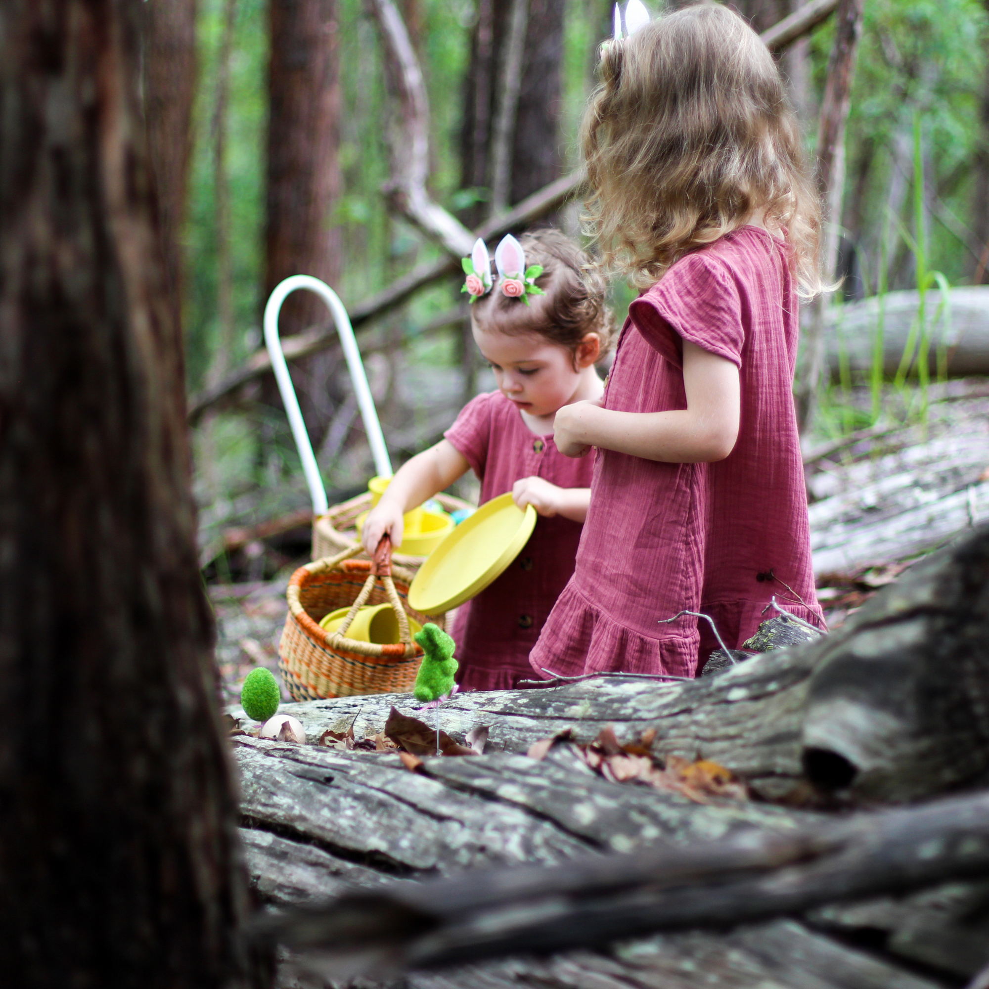 children having easter hunt in forest